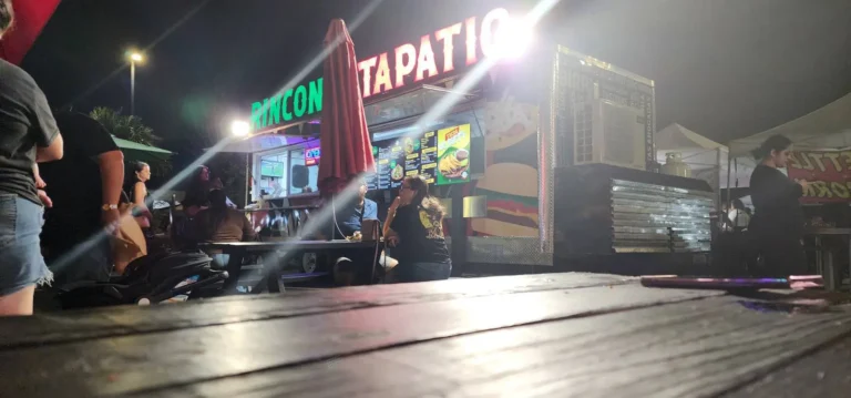 a group of people sitting at a table outside a restaurant
