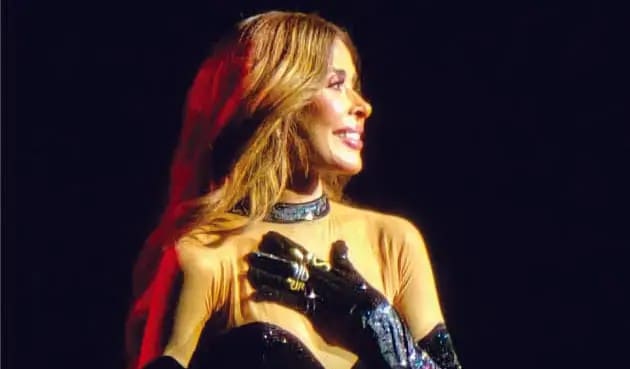 a woman wearing gloves and a gold shirt