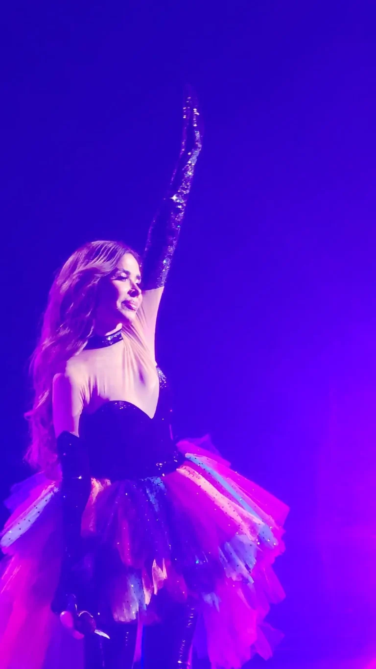 a woman in a dress with her arm up