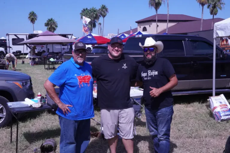 a group of men standing in front of a car