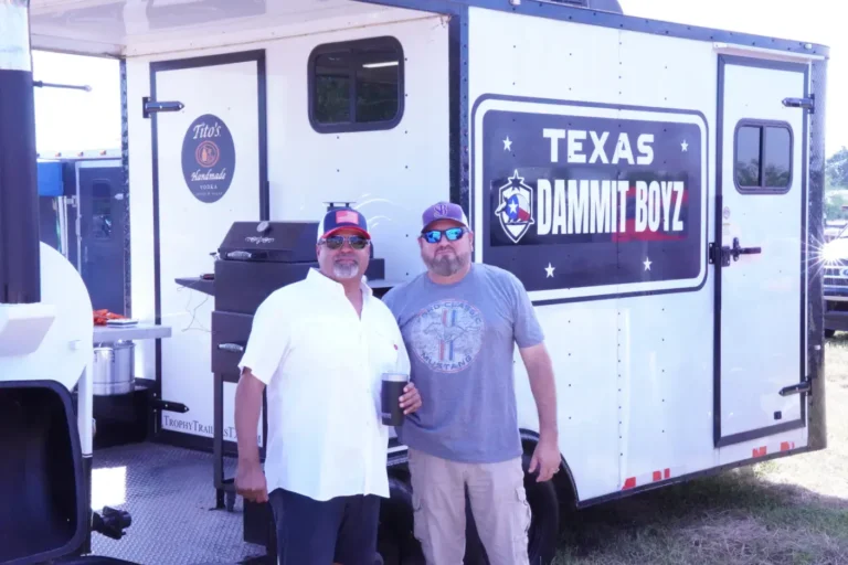 two men standing in front of a food truck
