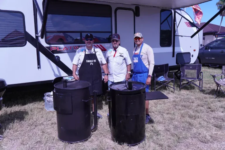 a group of men standing in front of a camper